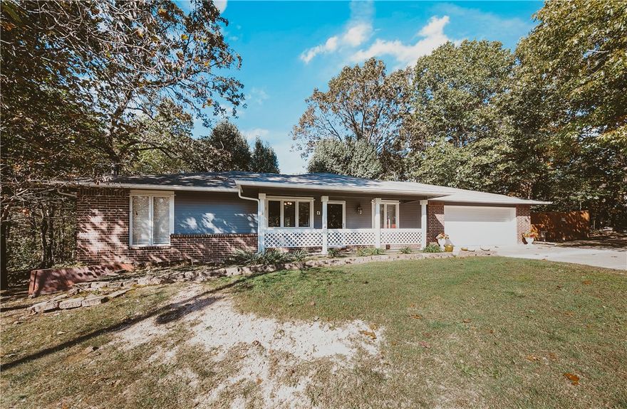 Additional Parcel # 16-03125 .27 acres comes with this home for a total of .60 acres.  3 bed 2 bath cutie, split floorplan. Well maintained home with completely level back yard , .27 additional acres next door also flat. Perfect to build a workshop,  2nd home for family or investment home. Oversized patio in back with main deck fully covered with lights, ceiling fan for many months of enjoyment. Home includes refrigerator, washer, dryer. Propane lines recently added with a gas range for the cook. Granite counters in kitchen, a great open floorplan for family gatherings. Tile floors in most of the rooms, carpet in guest bedrooms only. Extra large garage provides room for 2 cars & extra storage. Home sits on west side close to Lake Loch Lomond, bike trails, Highland Pub, dog park off Glasgow, Lakepoint Restaurant. Not far from Hwy 49 to Bentonville! Septic emptied new pump installed 2024. Dont miss this very affordable home in a beautiful, quiet location! Upgrade list available Cox Cable for Cable
