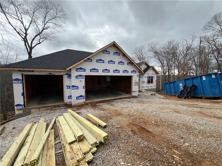 Beautiful new construction by Elite Thomas Homes on a spacious double lot on Bella Vista’s west side, offering ample room for a future shop or detached garage. Get under contract early to lock in pricing and personalize select finishes and upgrades. Estimated completion is mid-February 2026. 
This thoughtfully designed floor plan includes 4 bedrooms plus a dedicated office and an oversized 3-car garage. Enjoy an open concept living area with an L-shaped kitchen and a walk-in pantry. There is wood flooring throughout the main level and premium upgraded carpet on the stairs and in the basement. The primary bath features a dual vanity, tiled shower, and freestanding tub for a spa-like retreat. The lower level includes a media/game room with a wet bar, ideal for entertaining. Enjoy outdoor living with two covered decks—one off the kitchen and a second accessible from the lower level. Contact me for a current list of finishes and available upgrades.