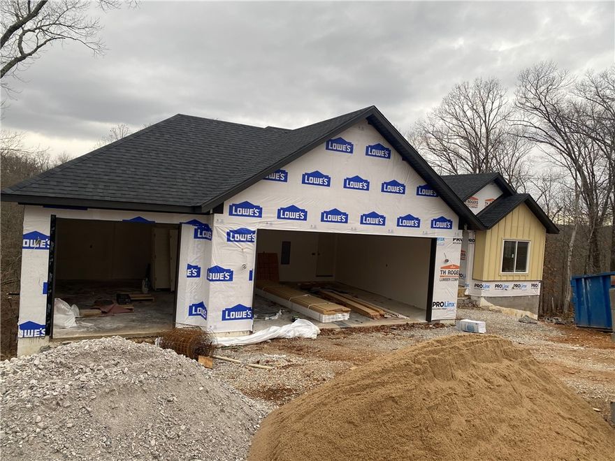 Beautiful new construction by Elite Thomas Homes on a spacious double lot on Bella Vista’s west side, offering ample room for a future shop or detached garage. Get under contract early to lock in pricing and personalize select finishes and upgrades. Estimated completion is mid-February 2026. 
This thoughtfully designed floor plan includes 4 bedrooms plus a dedicated office and an oversized 3-car garage. Enjoy an open concept living area with an L-shaped kitchen and a walk-in pantry. There is wood flooring throughout the main level and premium upgraded carpet on the stairs and in the basement. The primary bath features a dual vanity, tiled shower, and freestanding tub for a spa-like retreat. The lower level includes a media/game room with a wet bar, ideal for entertaining. Enjoy outdoor living with two covered decks—one off the kitchen and a second accessible from the lower level. Contact me for a current list of finishes and available upgrades.