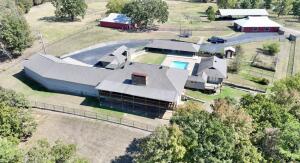 Stunning River Valley Retreat on 70+ Acres! Discover this sprawling 6,676 sq ft estate, perfectly situated on over 70 acres. This remarkable property features:4 Spacious Bedrooms: Enjoy comfort and privacy with generously sized bedrooms, each designed with it's own private bath.Equestrian Amenities: A 7-stall horse barn with a wash bay caters to equestrian enthusiasts. Perfectly designed for functionality and ease of care.Expansive Pole Barn: Additional storage and workspace in a versatile 40x100 pole barn, ideal for hobbies, equipment, or vehicles.Well-maintained pipe fencing. Indoor safe room. HOUSE SOLD ''AS IS''