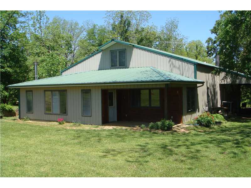 Great farmette. Unique metal building structured as a home with attached shop very low maintenance.. Beautiful 15 acres with pasture, woods and spring fed pond