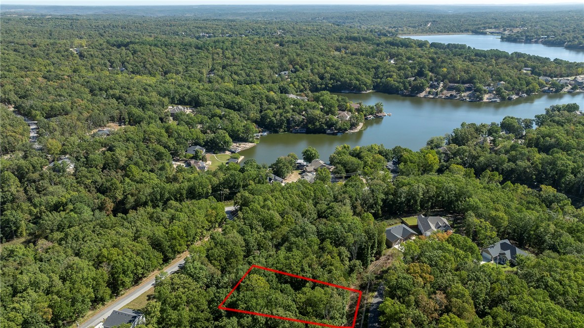 Wooded buildable lot near Loch Lomond Lake. Bella Vista offers five golf courses, seven private lakes,
miles of nature trails for hiking and biking, swimming pools, parks/pavilions, RV park and campground,
rec centers, playgrounds, basketball/pickleball courts, dining at the country clubs and much more. Don't
miss this chance to build your new home.