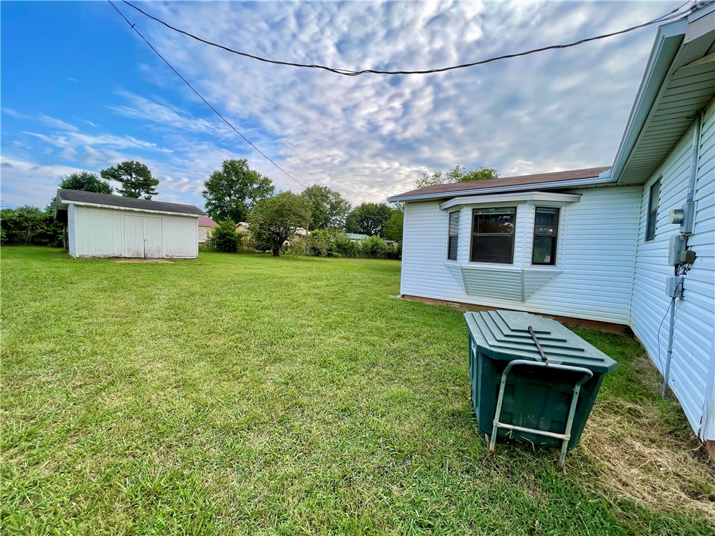 Experience the best of small-town living in this charming 3 bedroom, 2 bathroom home, built in 1991. With 1497 square feet of living space, the property features a versatile (flex) room off the kitchen. Enjoy easy access to town amenities, including a walking trail and splash pad just a short stroll away. Extensive storage options include a 600 square foot basement/cellar with outside entrance only, 10x16 outbuilding, and carport storage room. Sold as-is, with no repairs. Conveniently located approximately 30 minutes from Fayetteville and Springdale, AR.