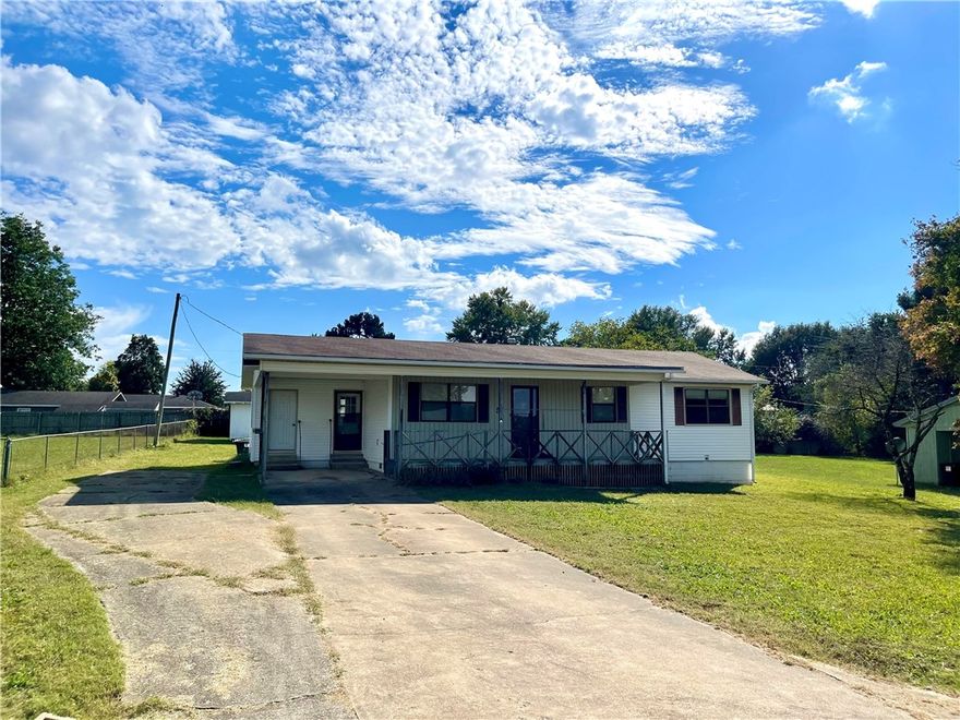 Experience the best of small-town living in this charming 3 bedroom, 2 bathroom home, built in 1991. With 1497 square feet of living space, the property features a versatile (flex) room off the kitchen. Enjoy easy access to town amenities, including a walking trail and splash pad just a short stroll away. Extensive storage options include a 600 square foot basement/cellar with outside entrance only, 10x16 outbuilding, and carport storage room. Sold as-is, with no repairs. Conveniently located approximately 30 minutes from Fayetteville and Springdale, AR. Utility availability is the responsibility of the buyer or buyers agent.
