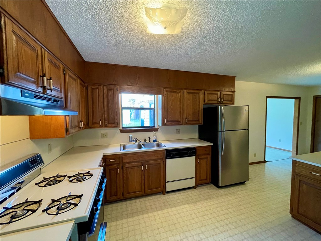 Experience the best of small-town living in this charming 3 bedroom, 2 bathroom home, built in 1991. With 1497 square feet of living space, the property features a versatile (flex) room off the kitchen. Enjoy easy access to town amenities, including a walking trail and splash pad just a short stroll away. Extensive storage options include a 600 square foot basement/cellar with outside entrance only, 10x16 outbuilding, and carport storage room. Sold as-is, with no repairs. Conveniently located approximately 30 minutes from Fayetteville and Springdale, AR.