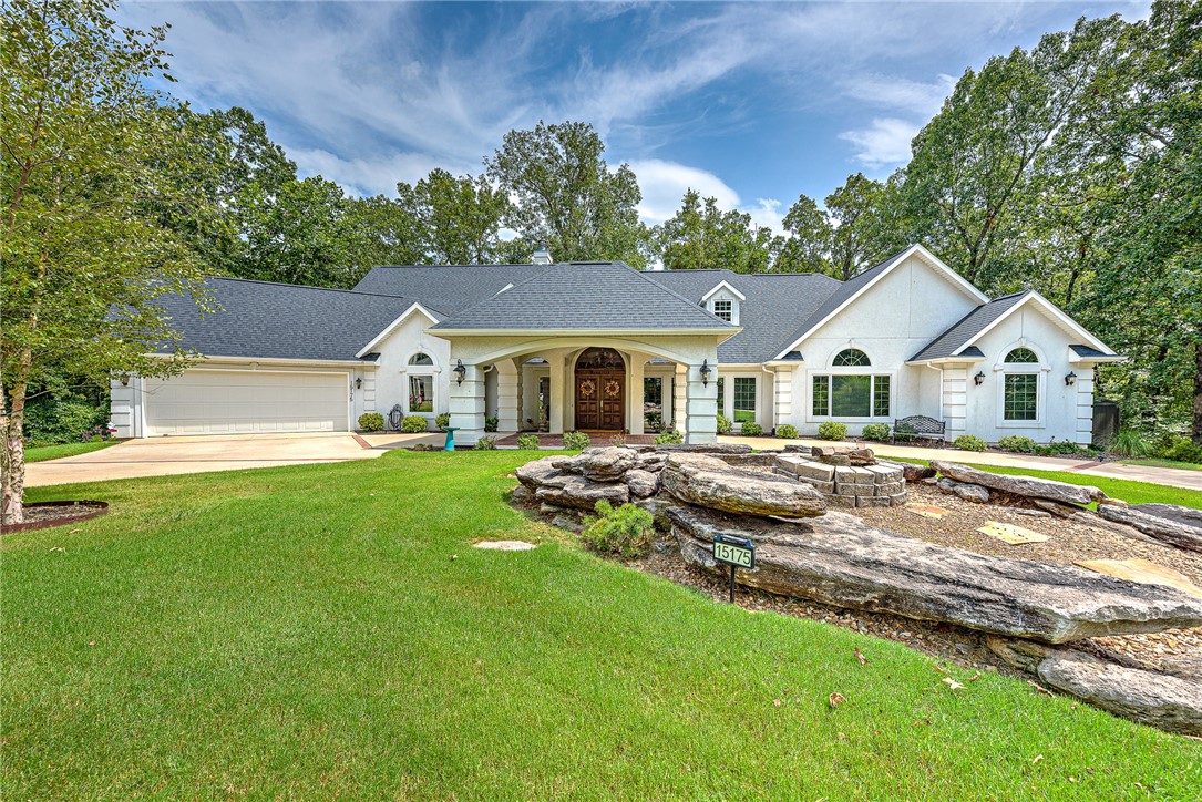 Exquisite Executive Estate in the Beaver Lake area! Nestled on 3.26 wooded acres this beauty was custom built by a local architect! The private drive is complete with a grand porte cochere entrance, not to be out done by the professionally landscaped park like back yard! The beautiful cherry wood built ins show off the new gas log fireplace and new carpet in the expansive family room. Recent remodel includes kitchen/dining- granite countertops, granite sink, backsplash, GE Monogram Series: Dishwasher, 36" Induction cooktop, 5 in 1(convection, toaster, warming, oven, microwave), Evergrind garbage disposal and Kichler light fixture. The Master baths have new quartz counter tops, sinks, plumbing fixtures, tile flooring, Roman tub, cabinets, carpet and Kichler lighting. 2 Daikin HVAC systems, window tint on front windows, nest thermostats, Alert Alarm System, 4' x 6' tornado shelter, LED lighting throughout, steel garage door entry, full yard irrigation all recently added, make this stunning home a dream come true!