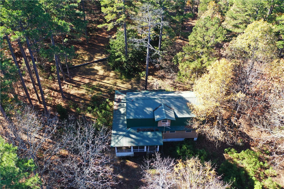 Prime location with no restrictions. The 2-story, 2-bedroom, 1-bath house with over 1,360 sq ft is waiting to be finished. Metal roof and screen in porch on 3 sides. Renovation in progress with new insulation and dry wall. A quaint home nestled back off the highway in a serene setting surrounded by large pine trees with abundant wildlife. This cabin has the potential to add your personal creative touch with a little TLC. Level 5.25 acres m/l on paved road awaits your outdoor adventures. The sturdy Quonset Hut with rollup and back door would make a great shop. A quick commute of 6 miles to the White River and Norfolk Dam and just minutes away is The Grill at Whispering Woods.