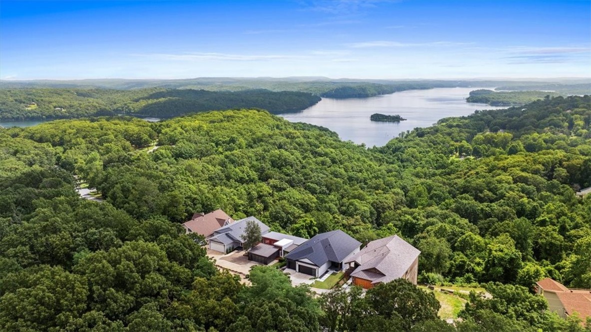 This incredible, modern lake house sits on two combined quarter-acre lots with what might be the best view on Beaver Lake!
With 4,000+ square feet across three stories, this home was built into the hillside to take full advantage of the view. Inside youāll find 3 oversized bedrooms, 5 full bathrooms, a home office, multiple living areas, and windows that flood every level with natural light.
he layout is unique by designābuilt to work with the slope of the land and make the most of the view. Itās functional, intentional, and anything but cookie-cutter.
Back on the market and made for slow mornings, long weekends, and lake days that linger a little longer. Whether you're hosting a houseful or enjoying the quiet, there's space to stretch out and take it all in. This one was built for the kind of life you donāt need a vacation from. Schedule your showing today!