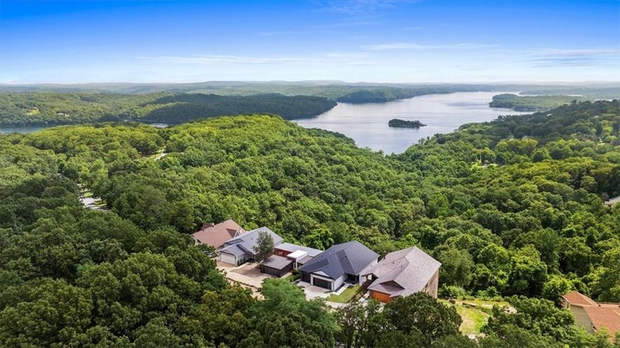This incredible, modern lake house sits on two combined quarter-acre lots with what might be the best view on Beaver Lake!

With 4,000+ square feet across three stories, this home was built into the hillside to take full advantage of the view. Inside you’ll find 3 oversized bedrooms, 5 full bathrooms, a home office, multiple living areas, and windows that flood every level with natural light.

he layout is unique by design—built to work with the slope of the land and make the most of the view. It’s functional, intentional, and anything but cookie-cutter.

Back on the market and made for slow mornings, long weekends, and lake days that linger a little longer. Whether you're hosting a houseful or enjoying the quiet, there's space to stretch out and take it all in. This one was built for the kind of life you don’t need a vacation from. Schedule your showing today!