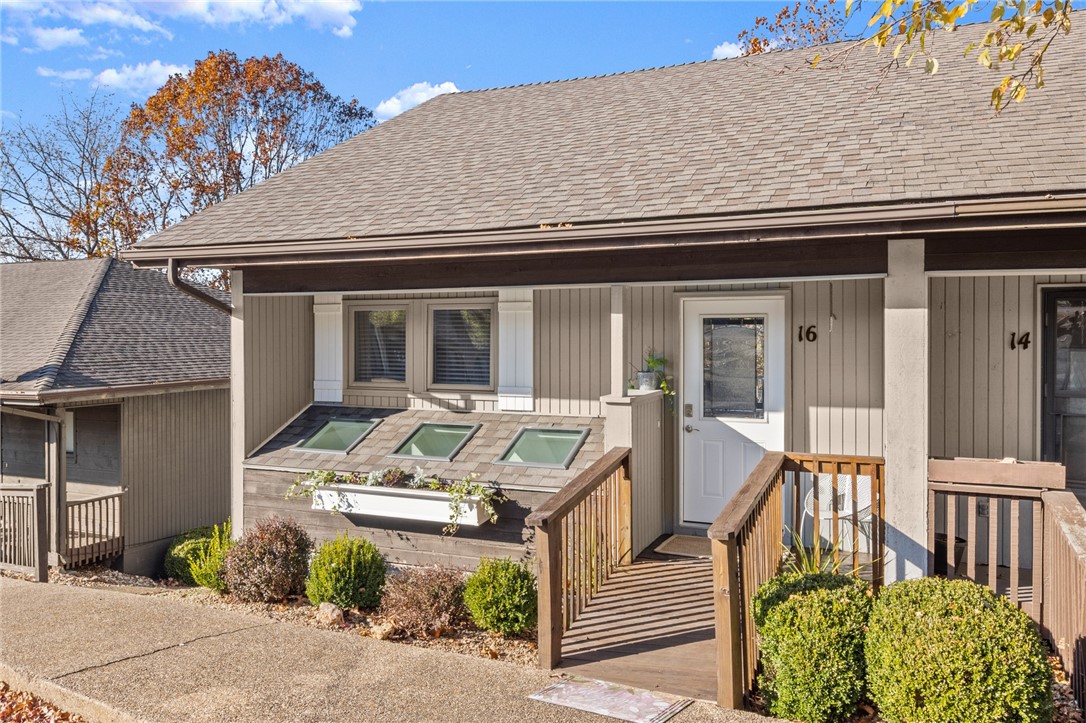 Fully renovated Bella Vista Townhome next to Lake Rayburn! This charming 2 Bed, 1.5 Bath home features a spacious living area w/private wooded views from 2 outdoor living spaces! Enjoy a fantastic location next to Lake Rayburn, Bike Trails, Restaurants & Grocery! Home includes high end features such as wood floors throughout, custom cabinets, gas fireplace & ship-lap detailing. Foyer entry opens to living & dining space w/access to the guest half bath. Large sliding doors & windows provide ample natural lighting & beautiful views. Living room has plenty of space for lounging or entertaining w/a beautiful fireplace. Kitchen offers stainless appliances, large windows, and abundant counter & cabinet space. Downstairs you have laundry along w/guest bedroom with large closet & a connecting bath w/great storage space & large double vanity. Primary bedroom is spacious & bright w/access to a large covered deck. Community amenities include Golf Courses, Club Houses, Fitness, Pools & much more!