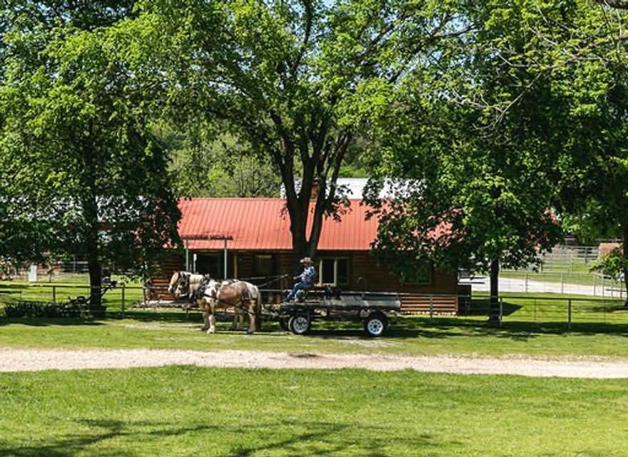 This 422 acre Ranch is located on the Arkansas/Oklahoma line at 25200 Ranch Rd, Gentry, AR 72734. Having 1.2 miles of the Spavinaw Creek makes this property a must see! Trout and other fish can be caught out of the creek on a regular basis and the creek gravel is readily available. The farms rolling hills give way to the beautiful bermuda grass creek bottoms. The pastures are divided into 10 separate paddocks to allow for rotational grazing. The 1516 Sq. Ft. house built in 2002 is a log home style having 2 bedrooms, 2 bathrooms and a very nice wood burning fire place. You will find all kinds of barns, outbuildings to store equipment, working pins, and even a roping arena! Deer, turkey, and other small game can be found on the acreage. This farm is as good as it gets with quality pasture, beautiful scenery, seclusion, and a Spavinaw Creek flowing through it!