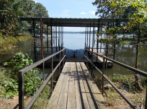 Boat Dock with 500 ft of water frontage on Piney Bay - covered and a Jet Dock system to keep your boat in the dry, all in your own Private Cove :-) Walk out to your 18'x36' in ground swimming pool(new liner purchased & to be installed soon) from a remodeled basement with a full kitchen, full bathroom and second washer & dryer hookups. Basement also has a beautiful fireplace for gathering after that late evening swim party. Shop is 30'x40' heated & cooled with a full bathroom & loft storage with outside stairs.