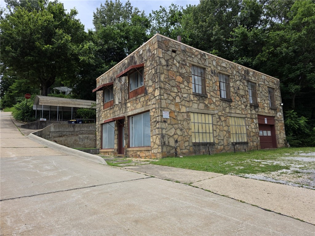 Unique property with great potential for both residential and commercial use. The upper level is a 2-3 bedroom, 1 bath living area that is 1544 Sq. Ft. with 2 parking spaces (one covered). The downstairs or main level of the property has always been used for commercial/business/storage purposes. With the majority of the property zoned as C-1 but the upper level has always been used as a living area you have both residential and commercial potential uses for this property. A portion of Lot 10 is also Zoned R-3. The Harrison Original Town Plat and revisions to it later don't always agree with the "real world on the ground". This property is an example of that issue.