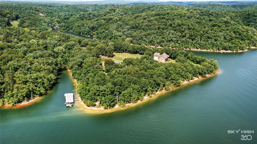 Super Location on Beaver Lake! A Global Luxury lake listing with 9+ acres of the best lake views on Beaver Lake, it's located directly across from Prairie Creek Marina, WOW! So many amenities including: Double PRO SS Refrigerator, 3 CM Exotic Granite countertops, 5 burner gas range, SS farm sink, subway tile backsplash, soft close custom cabinets, high top bar, two gas fireplaces, water purification system, engineered wood flooring, surround property security cameras (with more multiple stations available), knotty pine high ceiling and cedar mantles, wood beams, large wood deck with screened-in sitting area, covered downstairs concrete patio, oversized double garage, huge attic space above garage, two master suites on main floor, a bonus room, & private/office. Enjoy the custom horse barn & riding arena, 3 slip boat dock with a new boat lift and a swim dock, plus 1/3rd of a mile of beautiful surrounding shoreline.There is so much that this home has to offer! Don't miss your chance to see this one of a kind!