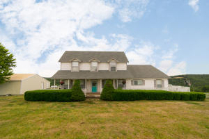 Stunning views of Boone County with this 4 bedroom, 3 bath, home on 40 ACRES. Private, end of the road setting. All new interior paint and floor coverings. You can enjoy the view from the large open family room/kitchen area or the master suite. 4th bedroom, ''John Deere'' room, is on main level and could be used as an office or hobby room. Wrap around porch. Large 40x50 shop building with roll up door, 220 electric, and a concrete floor. Land is fenced with a pond, 25 acres of pasture, 15 wooded acres. Bergman school district.