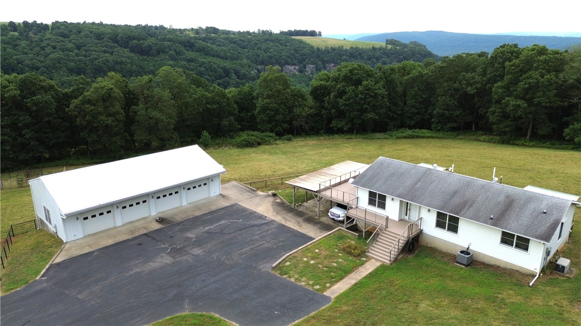 Everyone wants something between Jasper & Ponca with acreage for animals. Here it is! This 2832 SF house setting on 10 ac between Mt Sherman & Low Gap, Arkansas overlooking Horseshoe Canyon in the heart of the Upper Buffalo National River Region in beautiful Newton County, Arkansas only 8.1 miles from Jasper. Located 4.3 mi from Steel Creek Access & 6 miles from Ponca Access of the Buffalo National River. Features of the home include abundance of windows (including bay window), newer HVAC (2021), no carpet, large master bath with shower and separate tub, walk-in closet, three decks (composite) with electric operated Sun setter shades, security system, wifi controlled thermostat, abundance of storage, Kohler whole home back up generator, full finished basement (has not been partitioned), Hardy Board siding, large 2 bay attached carport, 56x30 4 car detached garage/shop, 40x30 barn, & working corral. Approximately 7 acres of pasture with a pond which would be ideal for horses and cows. Near Ozark National Forest.