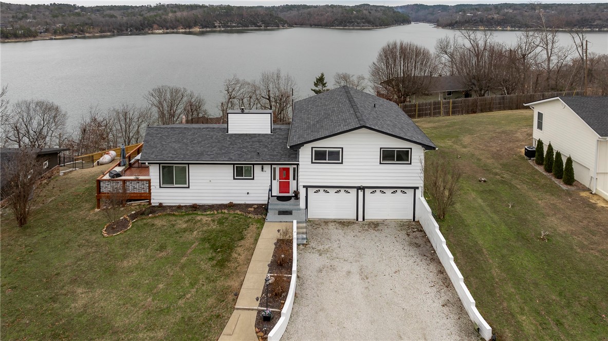 Stunning Beaver Lake Beauty! Move-In Ready with lots of updates throughout home, so come wake up to this breathtaking, year-round lake view from this beautifully updated 2,375 sq. ft. home, these forever views are expansive. This updated home features 3 bedrms, 2.5 baths, and two spacious living areas—one that can easily serve as a 4th bedroom—this home offers both comfort and flexibility. Enjoy a stylish, new custom kitchen with all upgraded appliances included. Home features fresh paint, new flooring, new roof, new deck, whole house generator adds comfort and security and so many added accents throughout, making it truly move-in ready. Step outside onto the expansive deck to take in panoramic lake views or unwind in the swim spa, which conveys with an acceptable offer. Located just 8 miles from downtown Rogers and the Railyard bike trails, with Prairie Creek Marina minutes away. Community boat launches nearby make lake living effortless. Come like the lake like in style and with lake views everyday!