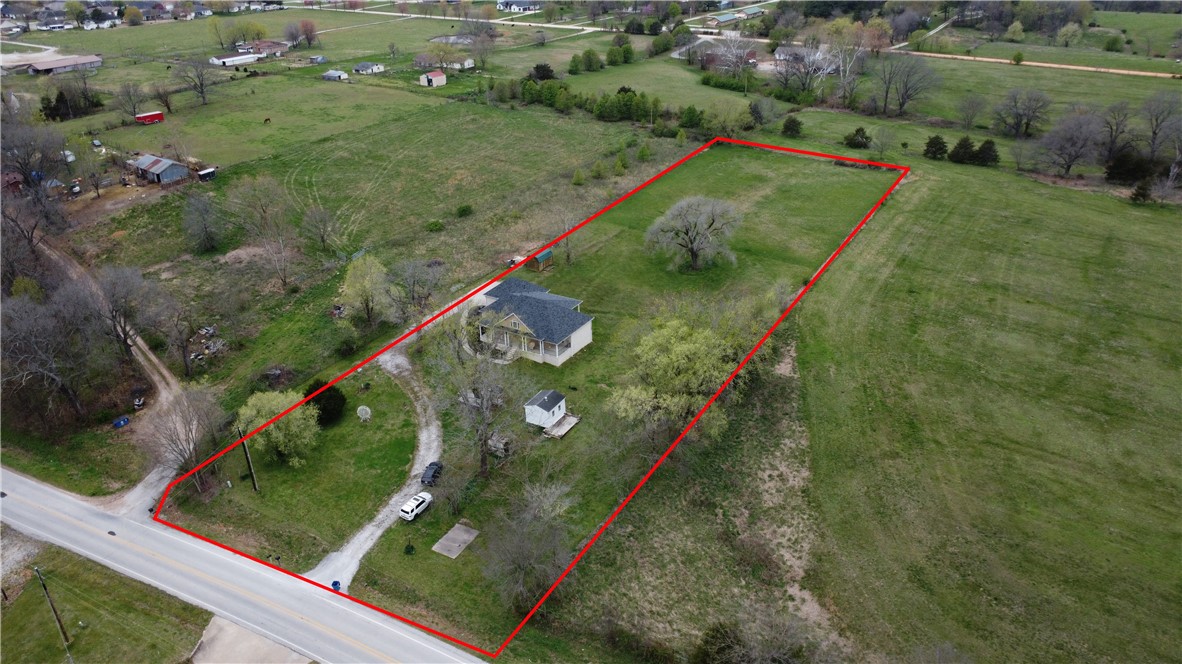Welcome to 2823 Hayden Road on 2.8 acres, a beautiful brick home that provides comfortable country living. As you approach the residence, you are greeted by a charming facade featuring a symmetrical design, complete with a welcoming covered front porch that invites you into a home of warmth and character. Stepping inside, the home unfolds into an open-concept living area and kitchen space. The kitchen is a triumph of design and functionality, boasting ample cabinetry, modern appliances, and sleek countertops that provide both a visually pleasing aesthetic and practical workspace. An island with bar seating is perfect for casual meals or as a gathering spot during social occasions. This home was designed with 3 bedrooms w/1 of the bedrooms not built out, it has a half wall and closet if someone wanted to enclose it for the 3rd bedroom. This 3rd bedroom space is currently used for additional living room space. This residence promises a retreat from city life while still close to local amenities. New Roof 10/2023.