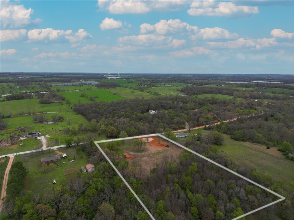 New Price!! $10,000 total price reduction.
Beautiful property outside city limits yet only 2 miles from downtown Gentry and 10 miles to XNA Airport. No covenants or restrictions. Easy access via paved road with last 1/3 mile on county-maintained gravel road. Approximately half of the land is cleared for homesite and barn; balance is wooded with abundant wildlife, including deer. Land also has a pond. City water meter already installed. Electric on property with up to 400-amp service for your house, barn, and RV. Has been surveyed and staked approximately every 100 feet on the sides and back of the property. The Septic system permit has been approved for a 3 bedroom home, and the location is fully staked out on the property. This property has a lot of work already done for your future home.