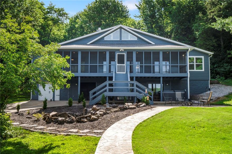 Welcome to your dream home nestled on 1.5 acres of prime real estate on beautiful Beaver Lake. This fully remodeled lakefront gem offers the perfect blend of luxury and relaxation with high-end finishes throughout. Step inside to discover a spacious, light-filled layout that opens up to a sunroom overlooking the pool, perfect for year-round enjoyment. Whether you're entertaining guests or enjoying a peaceful morning coffee, the serene views of your private pool and wooded surroundings set the perfect tone.
Outside, soak up the sun on the expansive patio or take a dip in the pool after a day on the lake. With your own private boat slip with 2 jet ski ramps, lake adventures are always just steps away. Whether you're looking for a primary residence, weekend getaway, or a vacation rental opportunity, this property offers it all. Don’t miss your chance to own a slice of lakefront paradise!