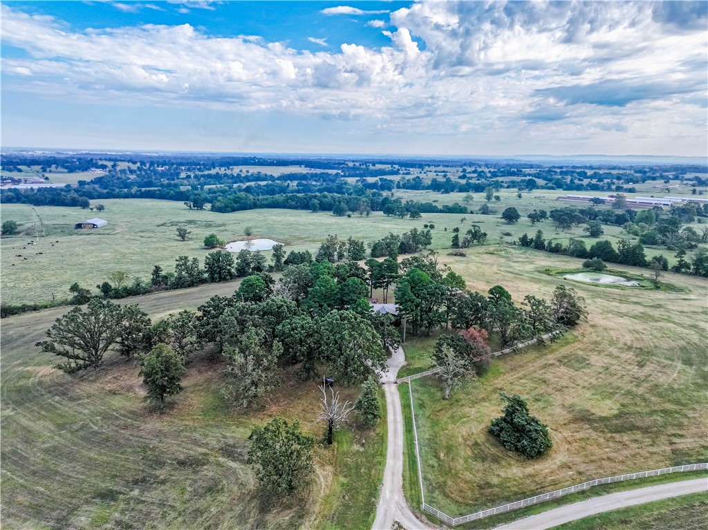 Beautiful Custom-Built Home on 36 Acres with Farm & Ranch Amenities. This stunning 5-bd, 3-bath custom-built home offers both comfort and functionality. Featuring an office, vaulted ceilings, and wood and tile flooring throughout, the home has an inviting eat-in kitchen with oak cabinets plus a separate dining room for gatherings. A cozy wood stove warms the spacious living room, while the completed basement provides additional bdrms and living space. The property is set up for both poultry and livestock. It includes three 32x380 chicken houses w/brand-new water and feed lines installed 2025 and existing premium contract in place. For livestock, there is over 3,000' of pipe fencing with all cross-fencing also in pipe, plus two water lines for convenience. A **4-stall horse barn with large pens, a dog pen—all equipped with water and power—**adds to the functionality.
A large pond enhances the beauty and utility of the 36-acre property, plus beautiful views all around makes this an ideal turnkey farm and homestead.