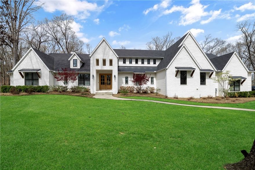 Wake up every morning at your own resort! This custom East Fayetteville Modern Farmhouse is nestled on 8+/- acres of nature lover's paradise! Inside this immaculate home, you'll find designer touches everywhere you look! Cathedral beamed family room, knotty pine ceiling in the kitchen, huge locally sourced white oak island. The kitchen has professional appliances including double oven, ice machine, oversized fridge, trash compactor. There is storage galore in the Butler's pantry with built-in desk and large walk-in pantry. More storage in the oversized mudroom and laundry room! Five bedrooms, 3.5 baths and flex space make this house so versatile for your lifestyle. The outdoor living space will be your new favorite room year-round with it's outdoor fireplace, twin size porch swing, dining area, and an outdoor shower! The huge 40x40 barn has utilities and plenty of space for all your recreational toys!  If you love nature, impeccable design, storage, and having your own private get-away, then this is your home!