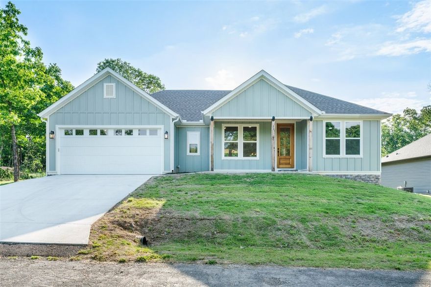 Enjoy the Bella Vista lifestyle from this  new-construction home ideally located near Lake Loch Lomond, scenic mountain biking trails, golf courses, and the Branchwood Recreation Center. This 3-bedroom, 2-bath home offers 1,677 SF of thoughtfully designed living space featuring an open-concept layout, soaring cathedral ceilings, luxury vinyl plank flooring, quartz countertops, and a split floor plan for added privacy.  The spacious kitchen flows seamlessly into the living and dining areas, creating an ideal space for entertaining or everyday living. The private primary suite offers a relaxing retreat with ample natural light and a well-appointed bath. Step outside to the fully covered deck, a peaceful extension of the living space perfect for morning coffee, evening gatherings, or simply enjoying the natural beauty of the Ozarks (and only 5 steps leading off the deck to your relatively flat back yard).