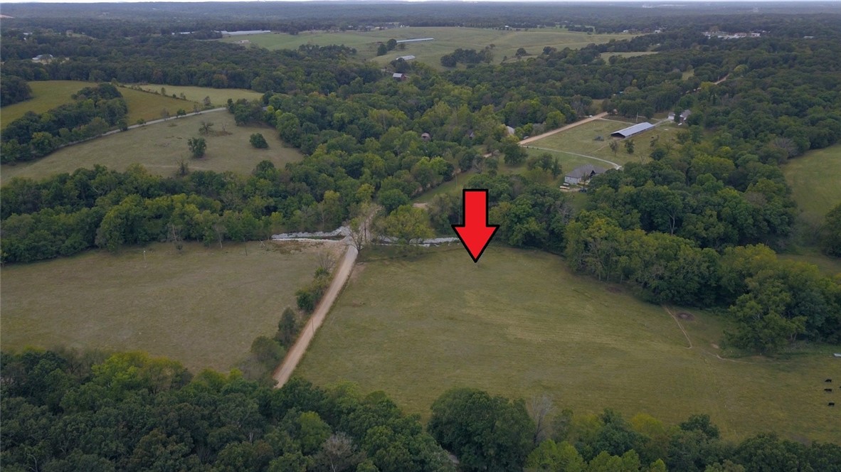 Bentonville schools! You will love this 7.01 acres with live year round creek. Enjoy the peacefulness watching the deer at sunset. Gentle topography perfect for several building sites. Become self sufficient with cattle, garden and whatever your hearts desire. Easy access to Neighborhood Market, schools and Bella Vista bypass.