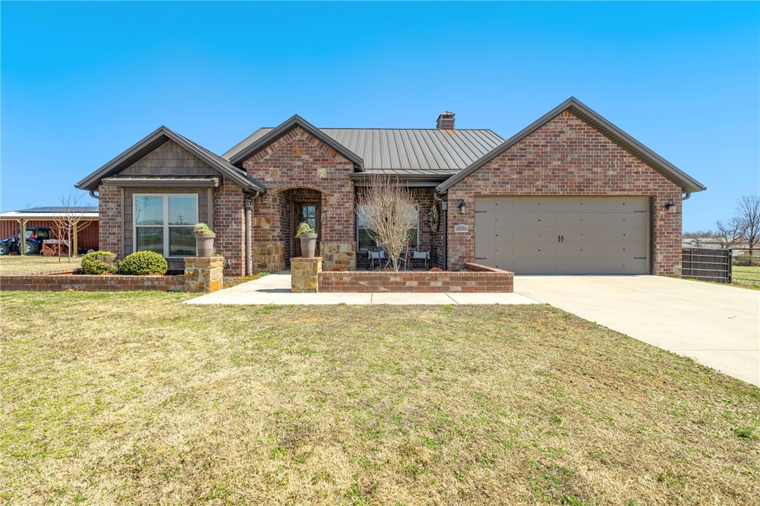 Donāt miss this exceptional 2019 custom-built home on 2 acres with shop & heated pool for living your best country lifeāall in a prime area convenient to XNA, Hwy 112, and all of NWA. This incredible home is loaded with amenities such as the high-efficiency wood burning fireplace in the living area, and patterned concrete floors. Donāt miss the ownerās suite, from the large soaking tub to the double vanity, and walk-in shower with tile and rock accent. Outside, the standing seam metal roof offers years of maintenance-free peace of mind, while the screened patio with gas fireplace and built-in grill provide year-round enjoyment. Patio also includes a built-in bar area overlooking your gorgeous, in-ground pool. Adjacent to the home is a 30'x52ā shop w/ two 15ā lean-to & 12ā doors on each end. Shop has 200-amp service including a 50-amp RV hookup and a second 30-amp hookup. Solar panels power both shop and house! The property also includes a variety of fruit trees, an in-ground storm shelter, and a riding arena.