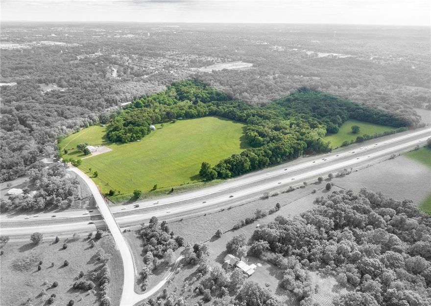 Future development opportunity on approximately 58.11 acres of highly visible land on Northeast J Street and Interstate 49. Property is within 2 miles of downtown Bentonville, Crystal Bridges Museum, The Momentary, future Walmart Home Office and numerous biking/hiking trails. It is located on both the north and south side of Interstate 49 and has approximately 1/2 mile of Interstate 49 frontage. See attached conceptual project plan from the city of Bentonville regarding the J Street Interchange - Tiger Blvd. to Interstate 49. Proposed interchange would border the subject property to the west.