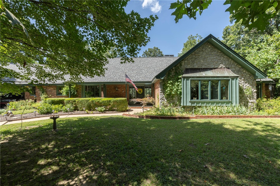 Location, location, location! Step inside this beautifully maintained ranch-style home situated on an expansive 2.34-acre lot in the heart of Fayetteville. Tucked into a quiet, established neighborhood, this property offers a rare blend of space, privacy, and unbeatable convenience. The home features a single-level layout with two spacious living areas, a generously sized kitchen ideal for gathering, and a dedicated workshop space. Enjoy warm Arkansas summers poolside in your own private backyard oasis. Whether you're looking for room to spread out or a place to entertain, this home checks all the boxes.
With quick access to nearby restaurants, shops, grocery stores, and trails, it’s hard to believe you're still in the middle of town. Properties like this don’t come along often—don’t miss your opportunity to call it yours.