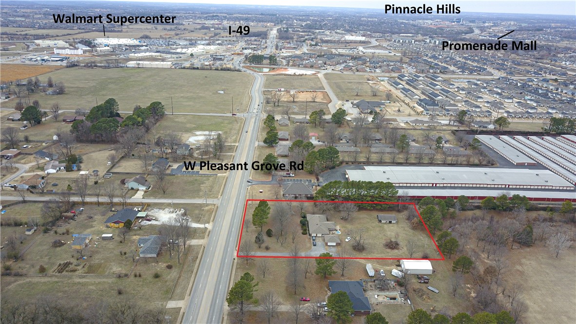 Close to 2 acres of prime frontage on the busy Pleasant Grove Rd. 4 minutes to I-49 and Walmart supercenter, 2 mins from HWY 71B. Property includes 2,376 sq ft house with attached garage, detached 2 car garage and Detached 2 car shop, would make a perfect residential office.