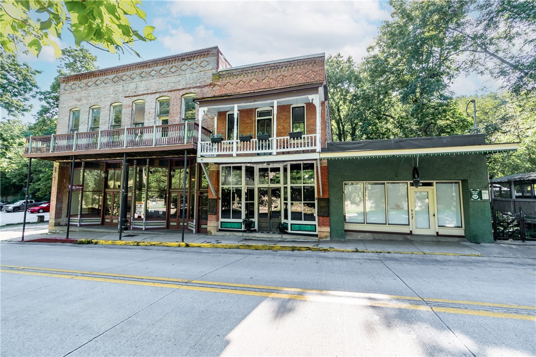 This historic building, which used to be Harps Grocery in 1885, has been renovated with new systems and features, while preserving its original charm and vintage style. The living space is open and bright, with high ceilings, deep windows and old doors, floors and moldings. The apartment has a loft design, with a large living and kitchen area, a cozy office space and a big bedroom with a balcony, as well as a bathroom with a deep tub and windows all around. You can enter the apt from Jackson St at street level. The front porch is next to beautiful gardens and a creek, making it a peaceful retreat. Currently operating as a vacation property but NOT priced to convey personal property or websites. Property would make a tremendous retail location as well with retail access on Main Street. This location is ideal for combining private living and public exposure.