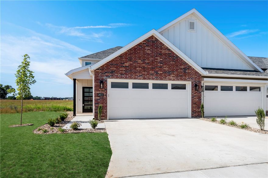 This beautiful new construction townhome offers Great location close to Osage creek elementary and Creekside middle school, close to the new Creekside park, close to the trails at Bentonville, the neighborhood offers a dog park, Pickle ball courts and a pavilion. A short drive to Walmart general office. Come see this property in this new and up and coming area. Lawncare is providing by the owner!! , surrounded by a vibrant green landscape. Come inside to find an open concept floor plan complete with modern touches and finishes. The kitchen features stunning white cabinetry with matte black fixtures, a spacious center island, and sleek stainless steel appliances. With 3 beds, 2.5 baths, a 2-car garage, and a serene backyard view, this home is the perfect place to call home. Located minutes away from all the best Bentonville has to offer - don't miss out on making this townhome your new home! Schedule a showing today.