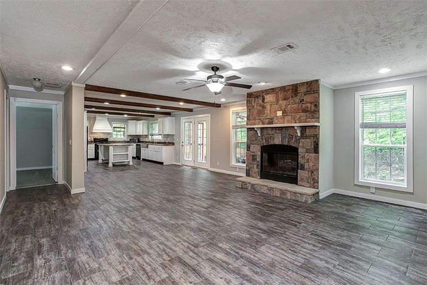 Like new double-wide on 3.5 acres. This is not your standard manufactured home. Introducing the 2021 Legend Platinum series, which includes numerous features typically found in site-built homes. These include a ceramic tile walk-in shower, huge soaking tub, and two vanities in the primary bath, tile backsplash and large island in the kitchen, built-in wood-burning fireplace with stone surround, real wood cabinets, wood beams, drywall throughout, and ceiling air vents. The exterior walls are constructed with2x6 framing and feature upgraded insulation to keep your energy costs low. Additionally, it includes an attached 1-car garage with extra storage space. Sip on some coffee and soak in the sunlight on your front porch and deck in the morning and then enjoy your favorite book on the covered back deck in the evening. The refrigerator, washer, dryer, and microwave all convey making this home as move in ready as it gets. The home is on a permanent foundation. *Septic system is permitted for 2 bedrooms.