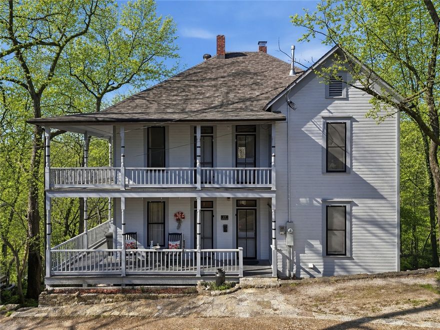 Virginia Castle, one of Eureka Springs' most prominent boarding houses, was built in 1906 for three sisters. The three-story home was purchased in 1980 by the current owners, who began an extensive restoration that became a labor of love.  Spacious rooms line the hallways on either side, with a central staircase connecting the floors. Each room has vintage heart pine floors, 9.5-foot ceilings, functional windows and transoms, and a door onto a covered porch. It’s the only historic structure in town with bay windows on three floors stacked one on top of the other, creating a stunning architectural element. The property includes two vacant lots that could be used for gardening, additional parking, or a garage. New roof 2024. New HVAC 2023. A renovations list is available for interested buyers. The home's central location makes it a quick jaunt to Spring Street shopping and dining, the Carnegie Library, or the Farmer's Market. There's an intricate system of trails you can walk and enjoy the many springs and gardens.