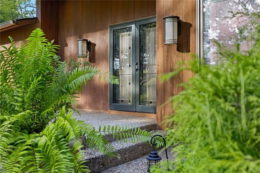 Nestled among 11 acres of Ozark beauty, this custom-built home offers a rare blend of privacy, craftsmanship, and natural elegance. The redwood exterior was re-stained and sealed in 2022, complementing the home’s timeless appeal. Inside, the gourmet kitchen features Wolf double ovens, warming drawer, electric cooktop, Sub-Zero refrigerator/freezer, wine fridge & ice maker, and a Wolf microwave—perfect for the chef at heart. The 2010 remodel also included a finished basement with a Viking beverage fridge and a second wood-burning fireplace, while the main level showcases a stunning 30-ft limestone fireplace as the focal point of the living area. The spacious primary suite includes dual walk-in showers. Paved driveway, black iron deck railing, and a detached redwood barn with 2 garage doors, carport, man door, and upper-level storage complete this exceptional property. Home with 38 acres see MLS#1326216