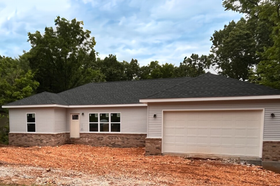 This stunning new construction home in Bella Vista offers 1,640 square feet with three bedrooms and two full bathrooms. The eat-in kitchen features elegant quartz countertops, while luxury vinyl plank flooring and energy-efficient LED lighting create a warm atmosphere throughout. The master suite includes a generous walk-in closet, and additional bedrooms provide flexible living space. Step outside to your private deck surrounded by mature trees for natural shade and privacy. Located in desirable Bella Vista with access to exceptional community amenities, this home combines modern finishes with the peace of mind of new construction.