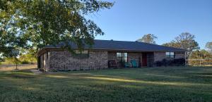 Ranch style brick home on 3 acres with an excellent country setting. 3 bedrooms, 3.5 bathrooms, 2 living areas and a 2 car garage. Includes a one stall barn with electricity and water. New roof May 2019. Propane backup heater. Lots of living space and plenty of room for your kids and animals to roam and play. Only 1 mile from Woolly Hollow State Park!