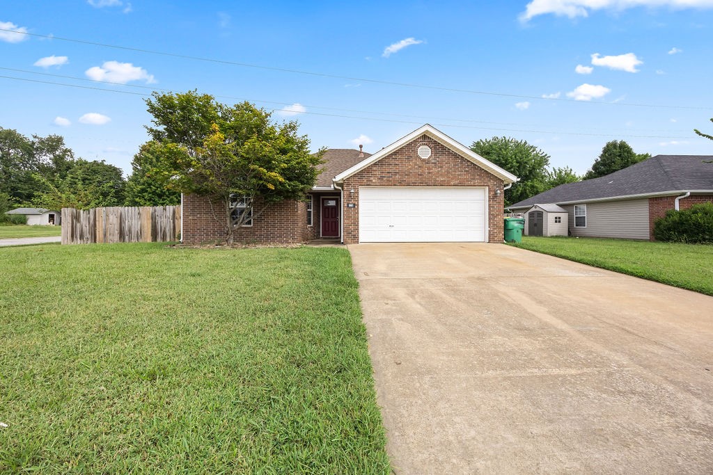 Adorable home in the Dogwood Subdivision. Wonderful open layout boasting vaulted ceilings, beautiful natural light and corner fireplace that helps create that warm and inviting atmosphere for everyone. Splendid eat-in kitchen provides the perfect space to make dinners with family or friends. Spacious bedrooms create functionality for all. Primary bedroom offers tray ceilings and walk-in closets. Moments away from shopping, dining and entertainment with convenient access to I-49. Storm shelter in backyard ensures safety during bad weather. Move-in ready and waiting for you!