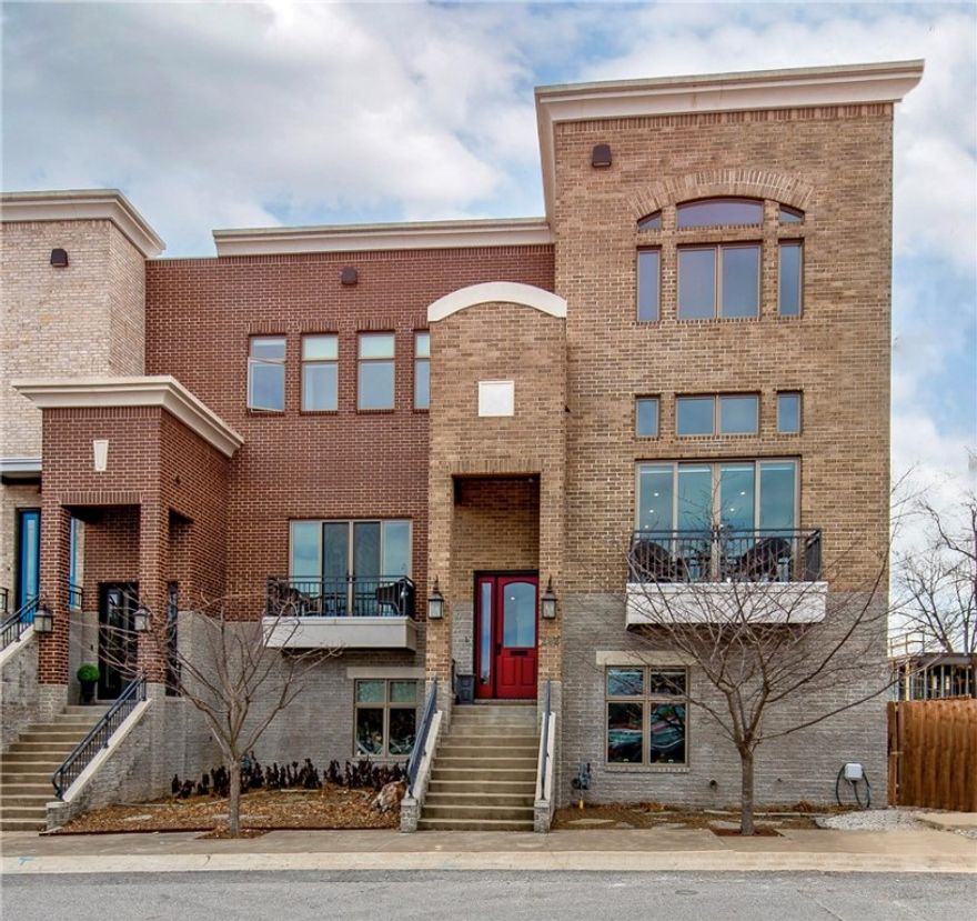 Downtown Bentonville living doesn't get much better than this! Steps from the downtown square, The Ledger and so much more. This one-owner, meticulously kept townhome offers 3 levels and is the first to be listed of this development. Upon entering, you will be greeted with cathedral ceilings and an open floor plan with tall windows. In the upscale kitchen, discover a fabulous 100-bottle dehumidifier wine cave, granite countertops, top-quality appliances, and ample storage space. Sliding doors open to the patio complete with a fire pit, entertaining area, retractable screens, and a living wall with sprinklers. Retreat upstairs to the primary en-suite to a 270 degree view featuring a spacious room and luxurious bathroom. The downstairs level boasts an additional living area with built-ins, a wet bar, and a bedroom currently being used for a workout space. Other amenities of this sophisticated and modern townhome include a tankless hot water heater, 2-car garage, and an elevator option.