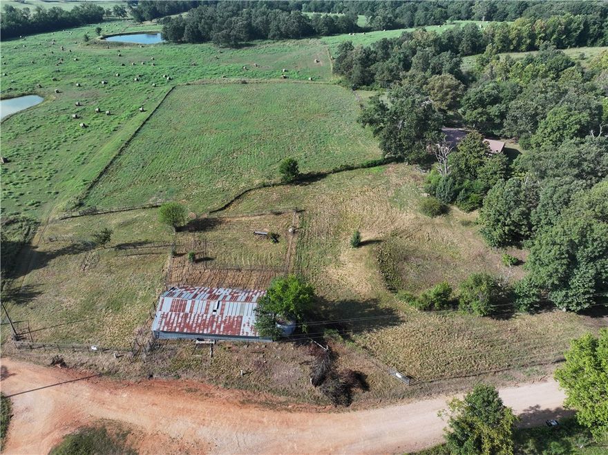 4.2 ACRES + BARN. Mostly level, completely fenced cattle farm land. 30'x50' barn with concrete runway thru barn with electricity. Needs septic and well (plumbing is in place from previous well). Barn only, nearby home is not included in this offering. Very desirable location 20 minutes from everything NWA.
Build a nice farmhouse or doublewide with views from every angle. Start a hobby farm, plant large gardens, raise goats, sheep, or cattle with the barn and pipe fence lots already onsite. Great access from road to unload right into the pen from the road. Live onsite - retrofit the barn with living quarters, "the barndo lifestyle." Small organic farms are gaining profitability and popularity each year. Back to the landers - here's an affordable and practical amount of land to get out the big city. Home schoolers - safe, room to roam, create, grow, and be a kid.