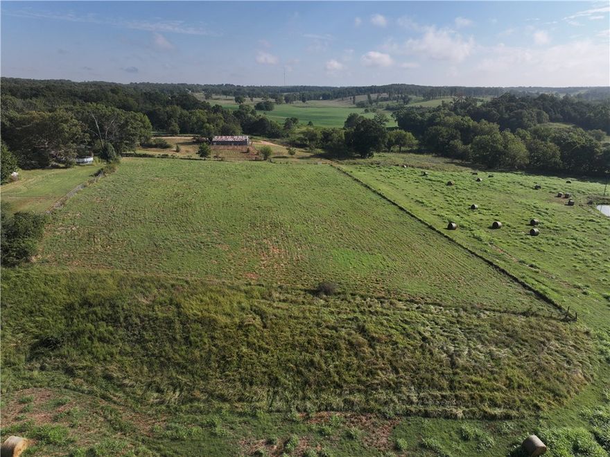 4.2 ACRES + BARN. Mostly level, completely fenced cattle farm land. 30'x50' barn with concrete runway thru barn with electricity. Needs septic and well (plumbing is in place from previous well). Barn only, nearby home is not included in this offering. Very desirable location 20 minutes from everything NWA.
Build a nice farmhouse or doublewide with views from every angle. Start a hobby farm, plant large gardens, raise goats, sheep, or cattle with the barn and pipe fence lots already onsite. Great access from road to unload right into the pen from the road. Live onsite - retrofit the barn with living quarters, "the barndo lifestyle." Small organic farms are gaining profitability and popularity each year. Back to the landers - here's an affordable and practical amount of land to get out the big city. Home schoolers - safe, room to roam, create, grow, and be a kid.