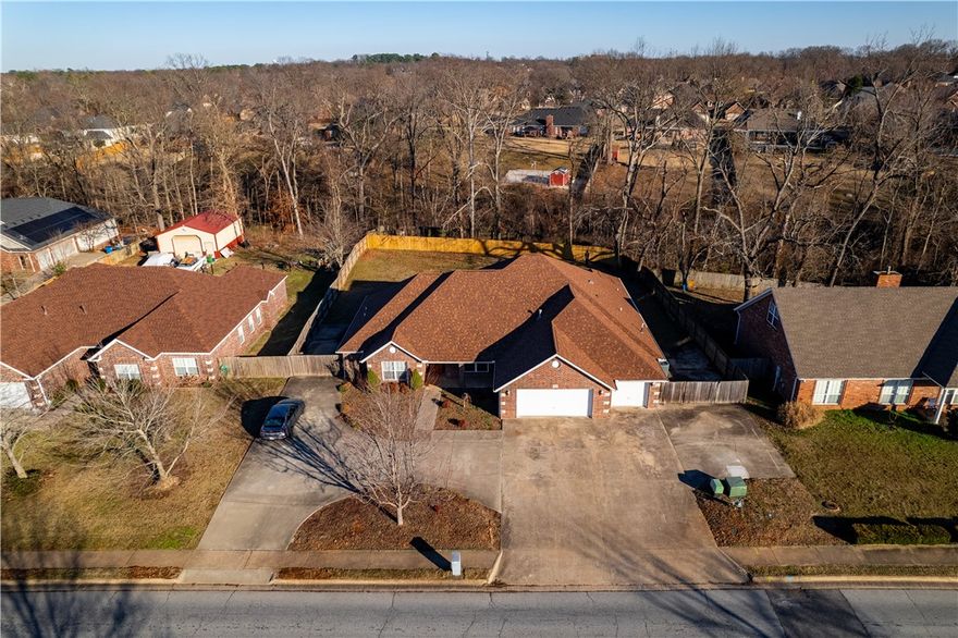 Beautiful 4 bedroom 2 1/2 bath with spacious 3 car garage and circle drive in Tunbridge Subdivision. Concrete parking behind gate on both sides, suitable for an RV. Large kitchen with double ovens and open space to work in. Large walk-in pantry. Eat in kitchen and a formal dining area. Office room as well! Split floor plan, all wood floors. Ample walk-in closets with built ins! Fireplace in living room and primary bedroom suite. Large covered back patio with private fenced in yard. All of this close to schools, Coler Mountain Bike Trails, Downtown Square and everything Bentonville has to offer. Will also be near the New 8th St. Gateway Park!