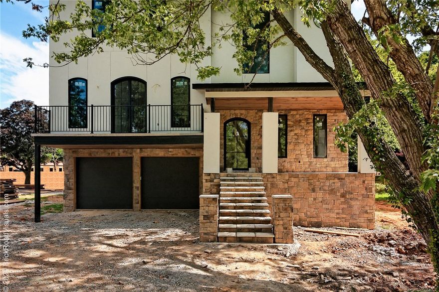 This custom designed & built home has all the features you could ever ask for.  Located just 3 blocks from the Bentonville Square.  Designed w/ an elevator so everyone can enjoy all 3 levels of living.  5 bedrooms, 4.5 baths, 5 outdoor patios, 3 indoor living areas & even a built in dog kennel.  The main level has an open kitchen, living room and dining room design. The kitchen has a waterfront granite island, Advantium microwave & oven, built in wine & beverage area, built in coffee area, custom cabinetry, vintage elder wood pantry door & built in side by side refrigerator.  All of this open living space flows to the outdoor patio which has iconic views of the Bentonville water tower.  The patio ceiling is made of Michigan sourced northern white pine.  There is a $10,000 grill allowance.  10' ceilings throughout.  Master Bedroom on Main level.   3 Bedrooms & 2 baths on top level.  1 bedroom on lower level. Lower level has a wet bar/kitchenette area which would enable the space to be used as a MIL suite if desired.