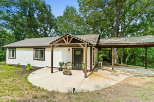 Nestled among the trees for privacy, this 2 bedroom/1 bath cottage is perfect for a small family, a couple wanting to downsize, or just a get-away home close to Branson and the many lakes in the area. Cricket Creek Marina and Table Rock Lake are only 15 minutes away! Bull Shoals Lake is 30 minutes away! The interior features a vaulted ceiling, a stunning island top made from Acaia wood, mini splits for heating and cooling, a wood stove, and lots of natural light. Enjoy a low maintenance metal roof, inviting entrance, back deck and courtyard, and 4.23 acres to hike and enjoy the seasonal creek. And, there's a 20 x 10 shed for storage. This 2 year old home is ready for a new family! This listing can also be purchased with 2.87 less acreage for $219,900. See MLS # 147794