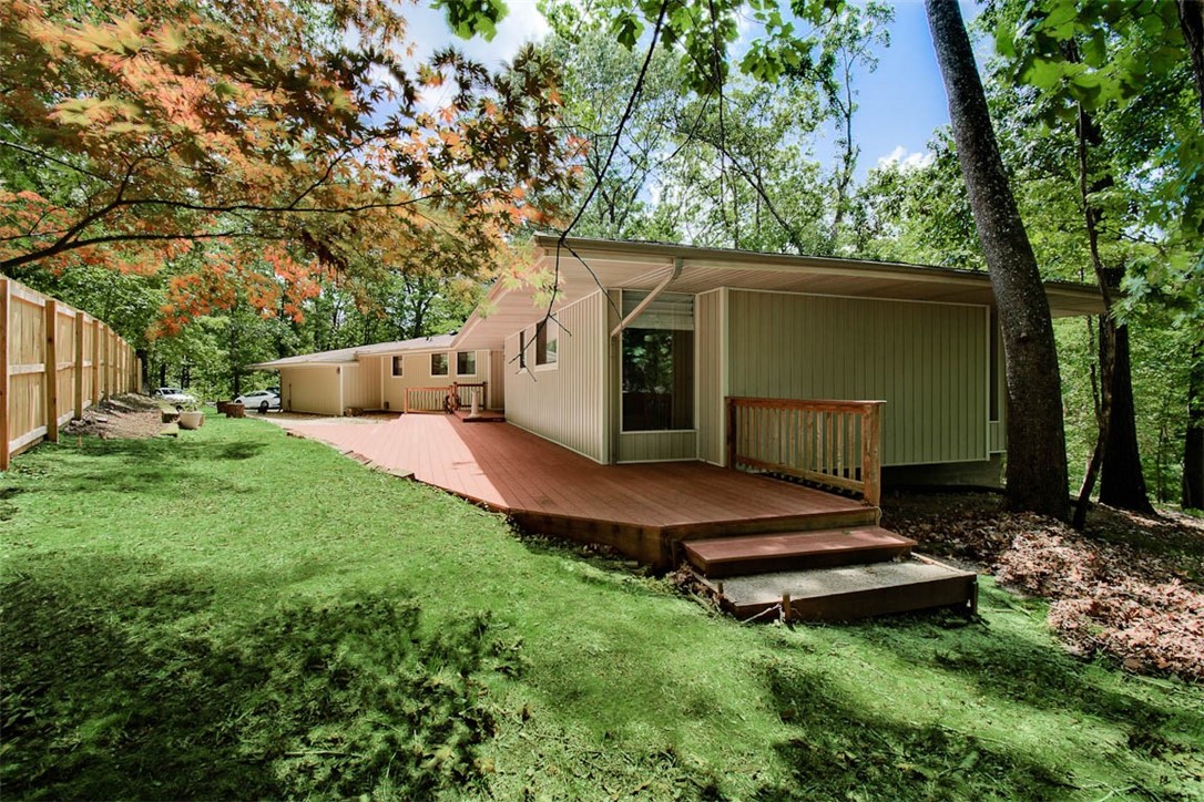 This an extraordinary home with a solid, mid century vibe. It is located on 2.7 woodsy acres, within a great subdivision, just 5 minutes from Lake Atalanta park and trails and 9 minutes from downtown Rogers. Peaceful, conveniently situated, updated, great for entertaining. - You couldn't ask for more!
