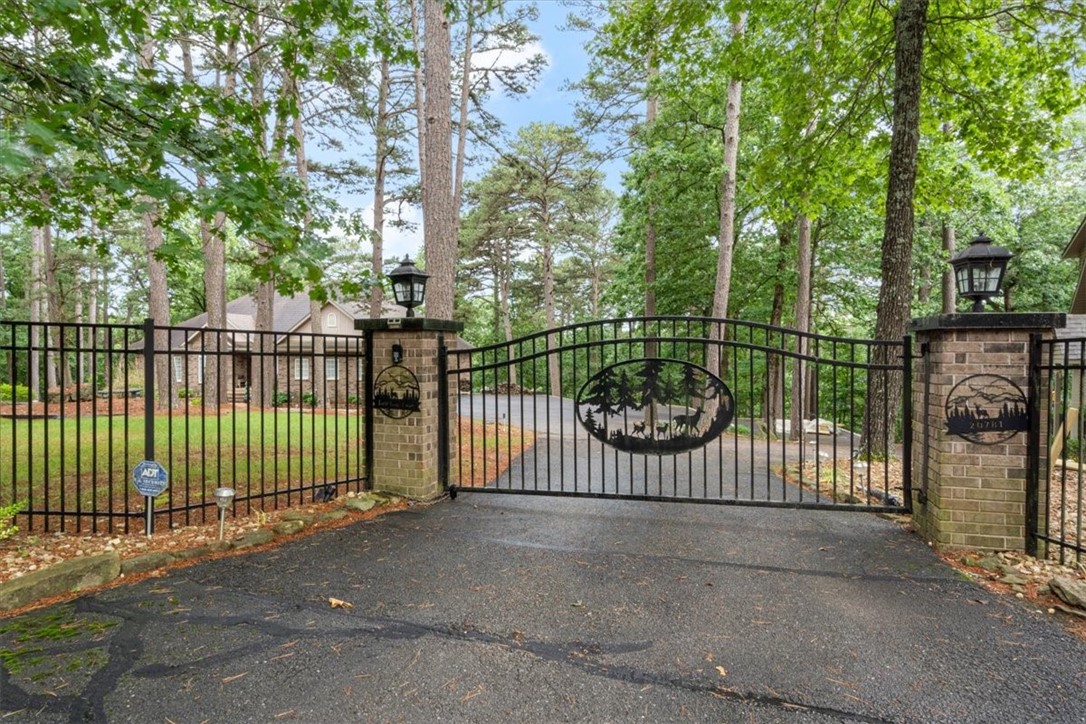 Impressive 5 bedroom Estate home from it's gates entrance, landscaping to interior design. This Beaver Lake home is complemented by the million-dollar residences nearby. An extraordinary home for generations to gather, live and thrive. Extremely well built with 11 inch concrete foundation walls, and energy efficient. A true entertainment oasis with a chef's kitchen, outdoor living with screened deck on the main floor and screened porch below with hot tub connection. Enjoy the large downstairs family room for gatherings and activities that also includes a safe room. The owners crafted this home with love. In addition, the second residence can be purchased with the primary for now for $450,000 which offers great opportunities, like Airbnb or for family and visiting guests. The secondary garages are deep for boat storage and more. Home includes covered boat slip with electric lift. Whole house generator. Built in woodburning fireplaces upstairs and downstairs and more. RV hookups at primary and secondary.