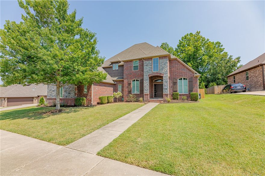 Beautiful home located in the desirable Oaklawn Hills Estates, this impressive traditional-style home built in 2014 offers 4 bedrooms, 3.5 bathrooms and 3,347 sq ft of light-filled living space. The open-concept main floor features a gourmet kitchen with granite countertops and stainless appliances, seamlessly flowing into a spacious living area with a gas-log fireplace. Enjoy a formal dining room, dedicated office/den, and a luxurious primary suite with a spa-style ensuite. Upstairs, three additional bedrooms provide ample space for family or guests. Outside, a covered patio off the living room and deck off the master suite overlooking a fully fenced backyard with wooded space beyond the fence, while the oversized 3-car garage and long driveway offer plenty of parking. Built in Storm Shelter in the garage gives protection & peace of mind when unsettling storms come rolling in. Nestled near the end of a cul-de-sac with easy access to biking trails within the subdivision and a short drive to downtown Bentonville.