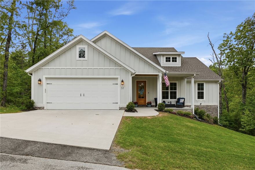 Located near the end of a quiet cul-de-sac, this 3 year-old 3-bed, 2-bath home has been well-cared for and is ready for new owners. Step inside to a light and bright living area featuring wood floors and gas log fireplace. The kitchen is sleek and modern with quartz countertops and an island with storage and seating. A sliding barn door conceals the pantry while giving the room a stylish touch. The primary bedroom offers a private retreat, with an ensuite bathroom designed for rejuvenation with a soaker tub and large tiled shower. A mudroom and large laundry add everyday convenience and functionality. Don't miss the Murphy bed in bedroom 2. Enjoy quiet evenings on the deck, or entertain guests. An added back patio on ground level adds space to sit while enjoying the yard. The property is surrounded by trees and backs up to POA property which means no homes will be built directly behind. Located close to grocery stores, restaurants, and all of Bella Vista's amenities, this home is ready to become your next retreat.